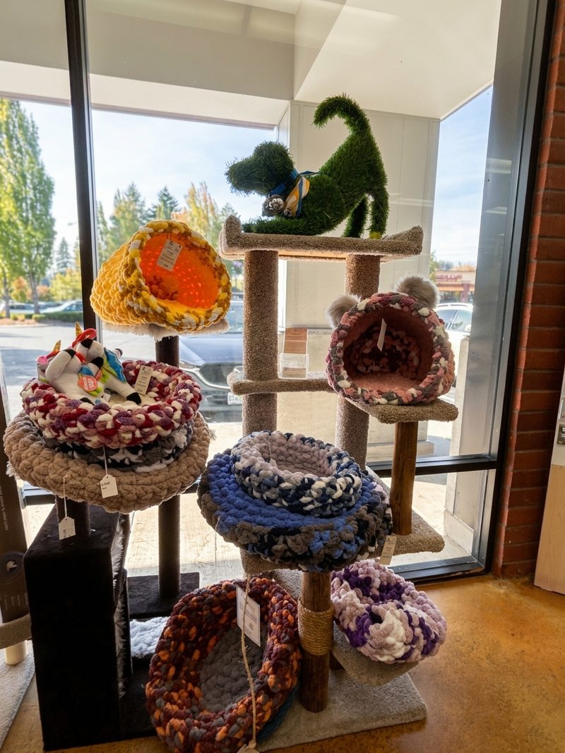 Hand-knitted pet beds stacked on a cat tree by the window